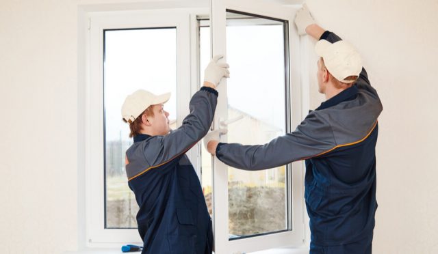 two men replacing a pvc window