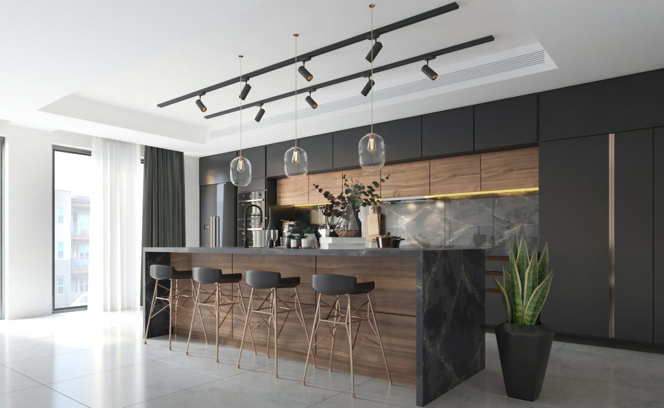 Track lighting in the ceiling of a black and brown modern kitchen, with grey marble backsplash