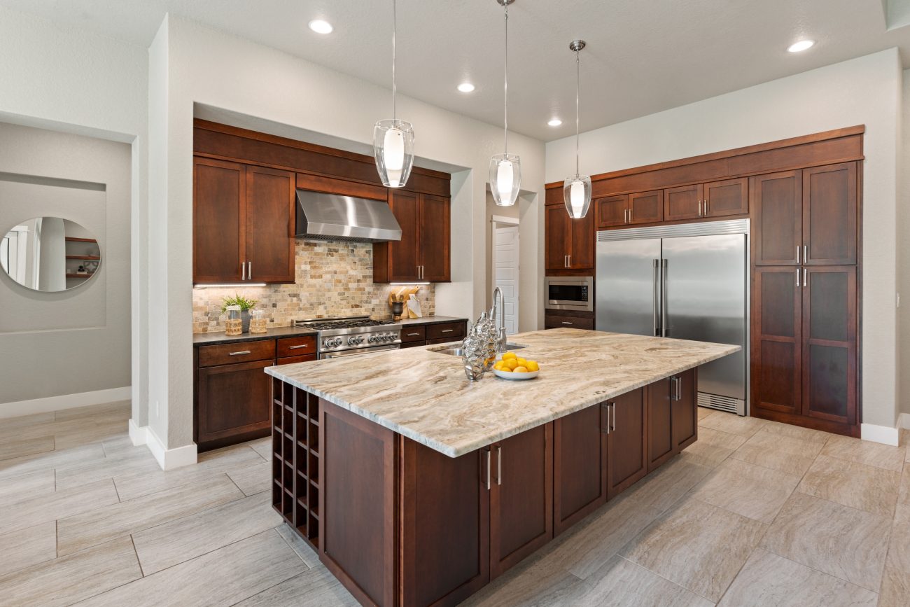 Modern kitchen with walnut wood cabinets and cupboards, extralarge refrigerator, spacious island and brick backsplash