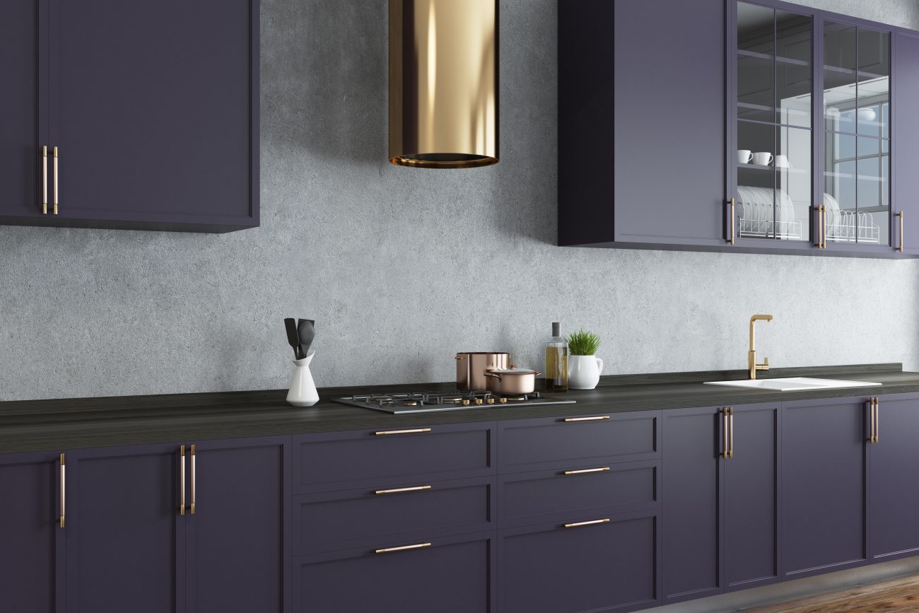 Modern kitchen with gold cooker hood, dark purple cabinets