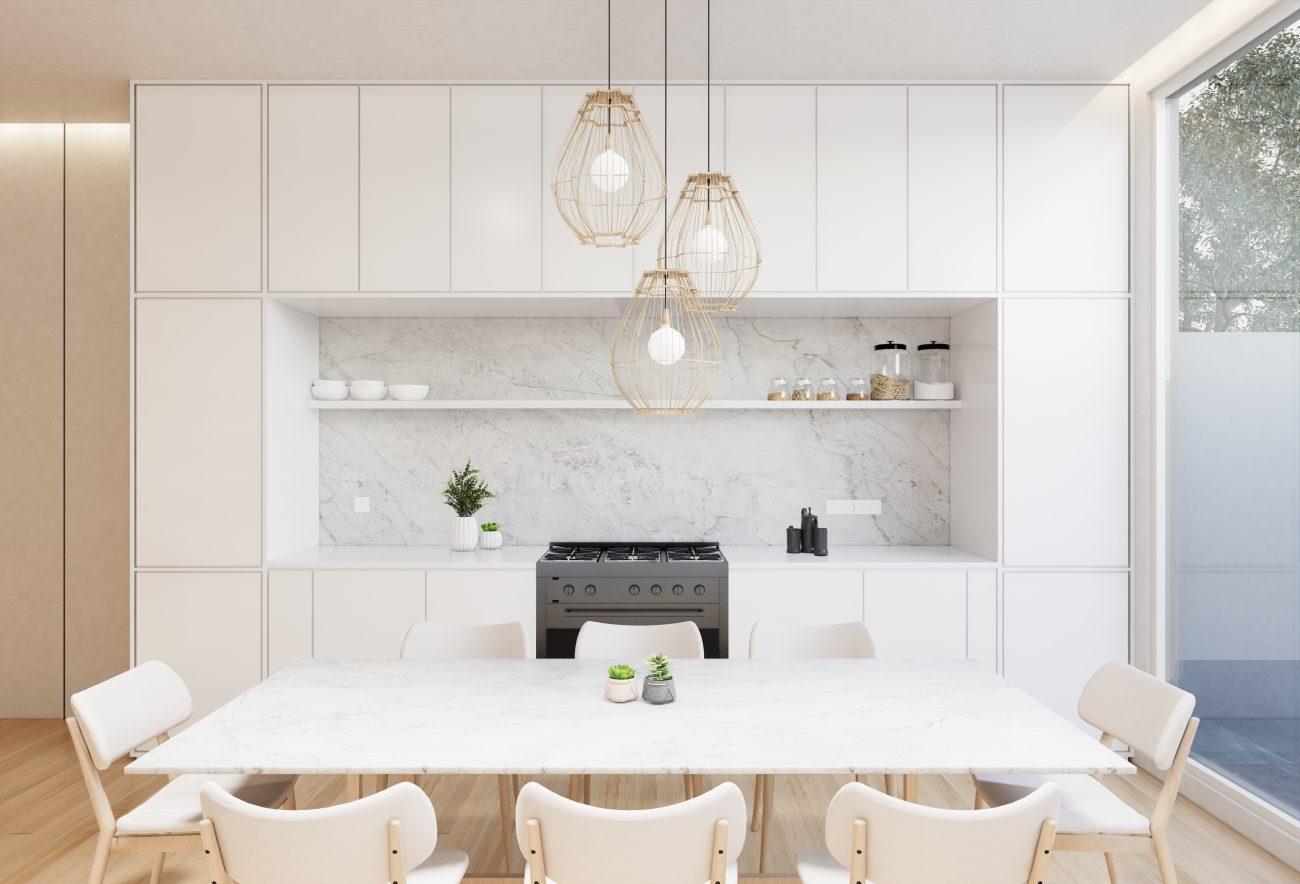 Three luminous globes suspended above a large white dining table set in a modern kitchen with handleless cabinets