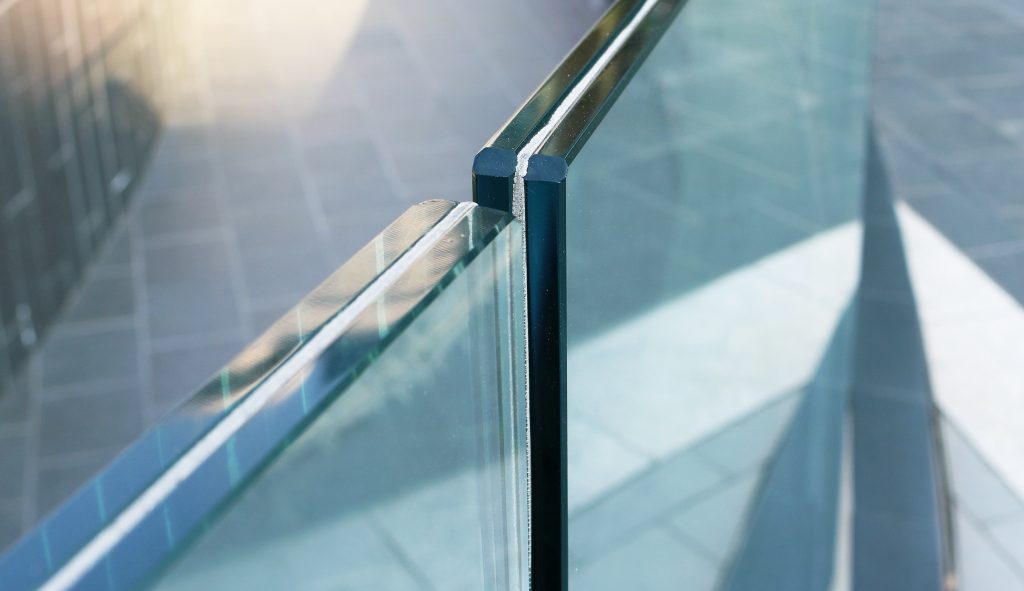 Close-up of a laminated glass guardrail, detailing the resin layer