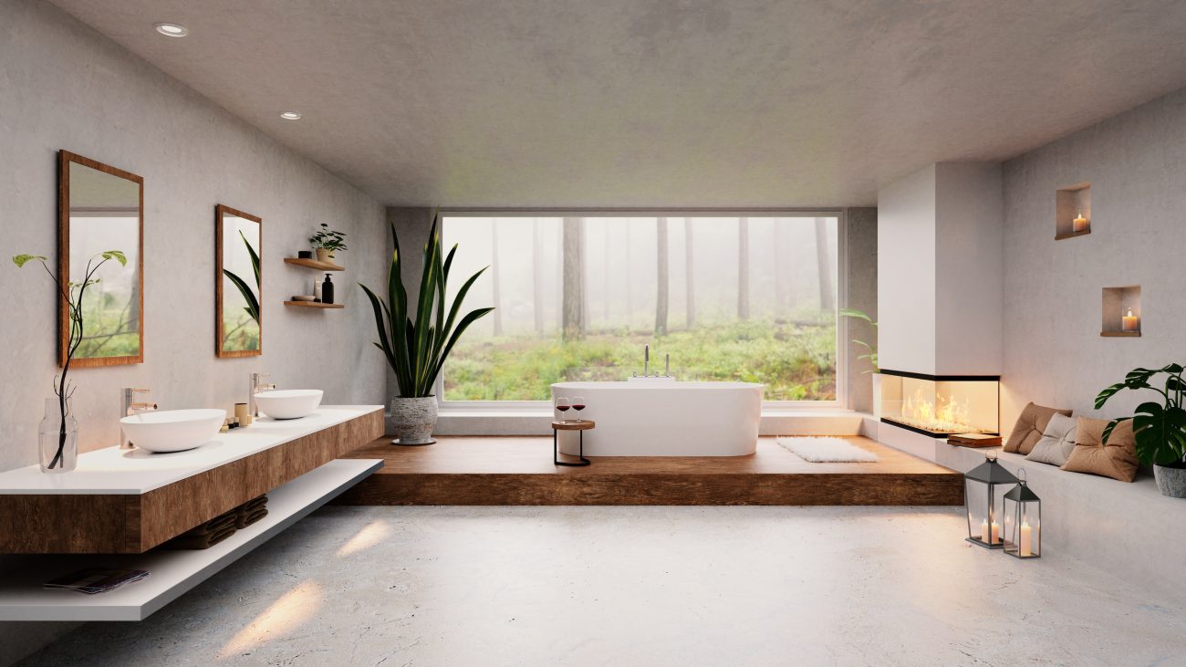 Luxurious and spacious bathroom with windows overlooking a forest, a wooden platform and vanity, freestanding bathtub, and two white porcelain basins, a three-sided gas fireplace in a white chimney, and lanterns with lit candles