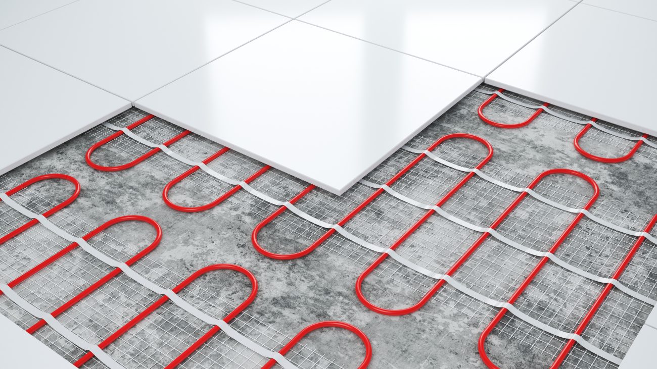 Detailed view of heating elements under the white tile floor of a bathroom