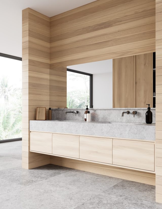 In a luxury bathroom, floating double sink vanity with concrete countertop and light wood cabinets in a wood niche, square mirror