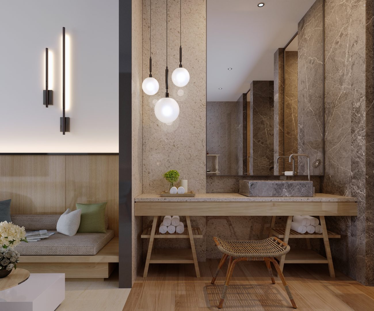 In a luxurious Japandi-style bathroom, an alcove with marble and travertine wall and large mirror, featuring a built-in wooden vanity with a travertine countertop on trestle shelves, a grey-veined marble basin, a small rattan bench, and three frosted globe pendant lights. In the adjoining living room, a Japanese floor sofa, coffee table, and slim black wall sconces