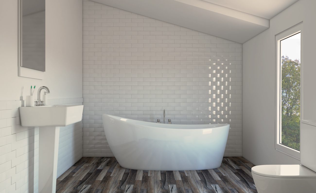 Salle de bain blanche lumineuse à plafond incliné, mur à carreaux métro, lavabo sur socle, baignoire autoportante et plancher chauffant à revêtement en lattes de bois aux diverses nuances de gris