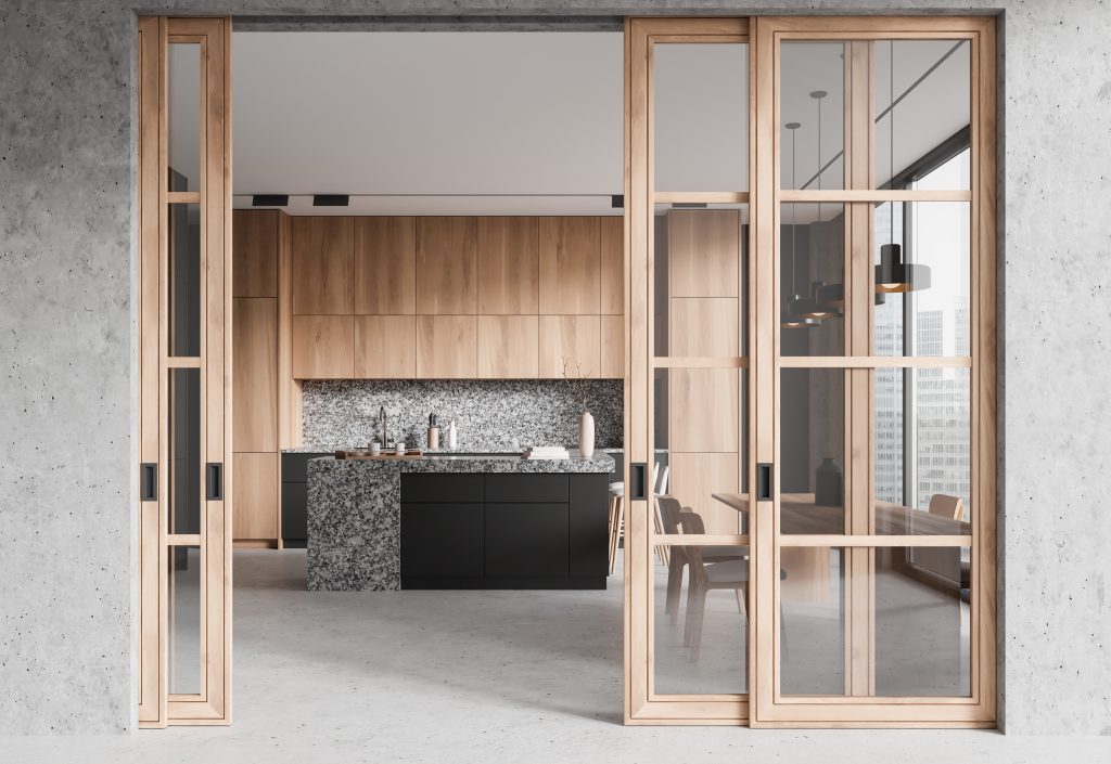 Elegant kitchen behind glass doors with gray concrete floor