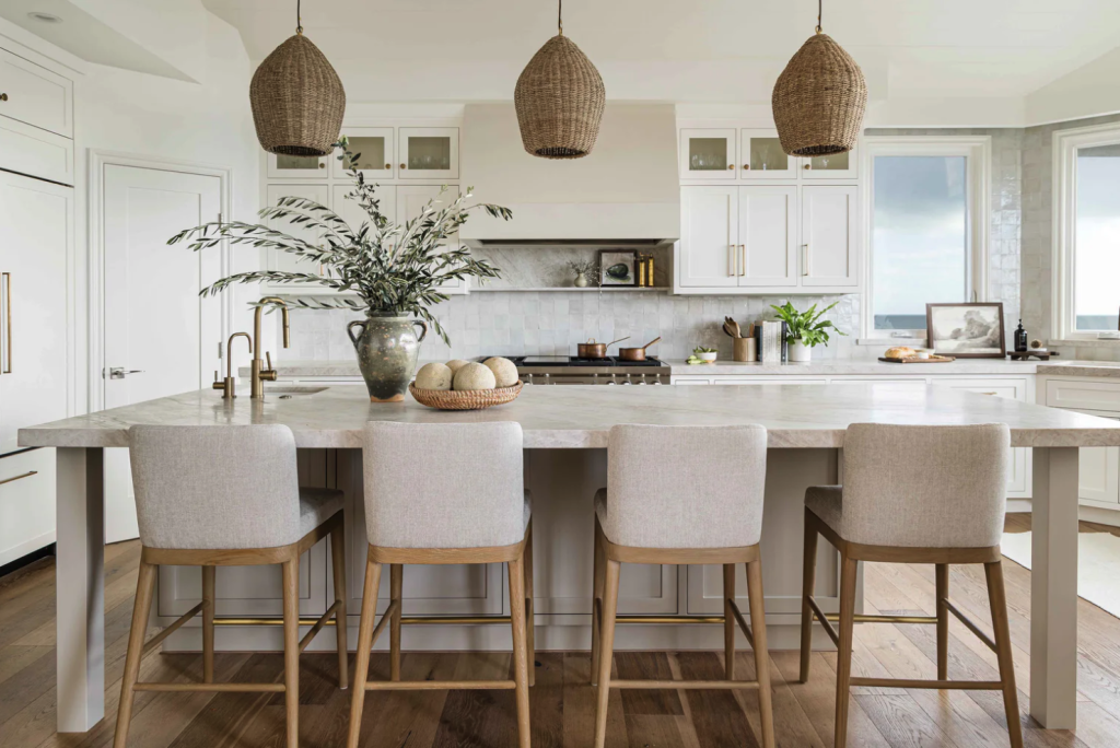 Bright kitchen in shades of white, beige and cream, including oversized plaster hood  