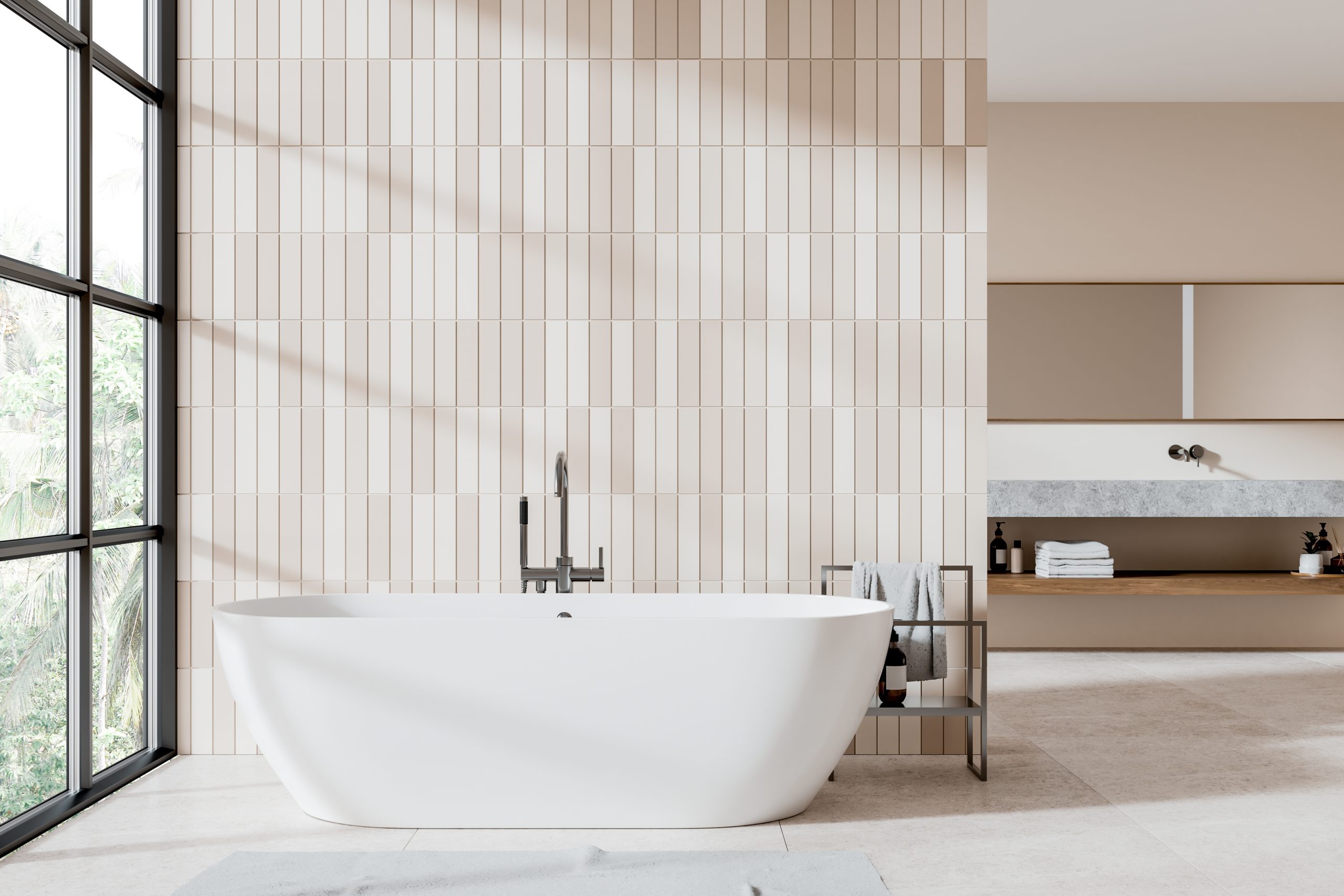 Bathtub in front of a vertical beige tile wall 