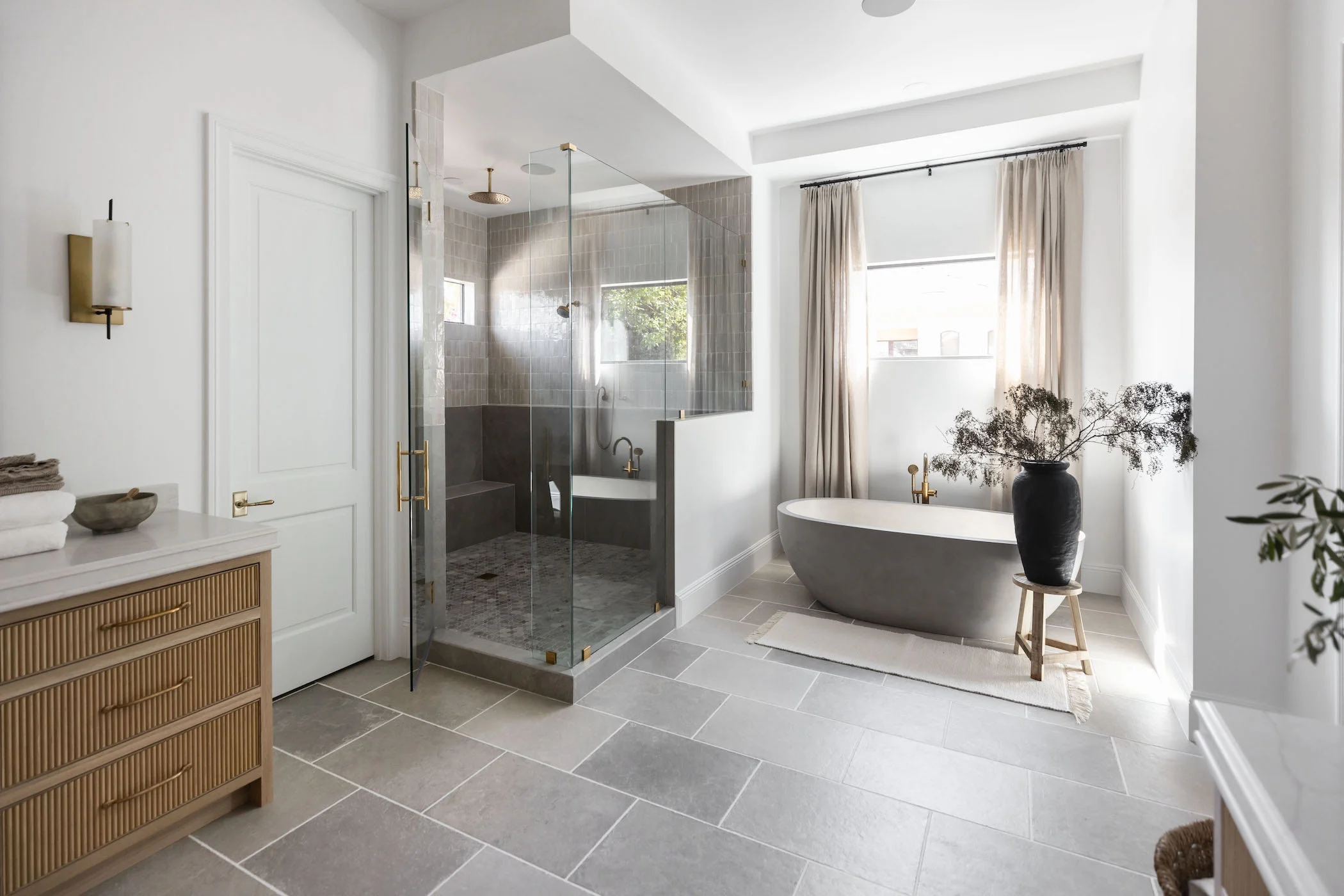 Two patterns of gray tile on bathroom floor and shower floor 