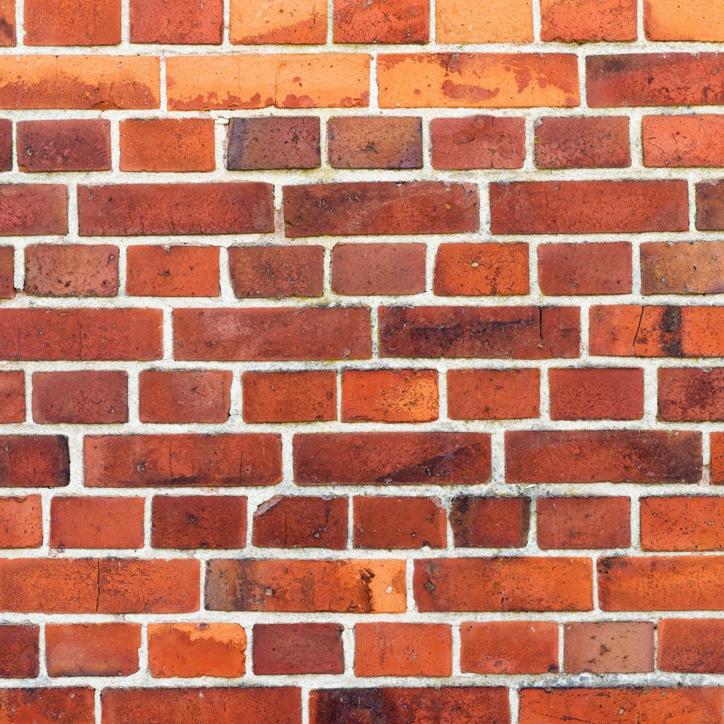 Red brick wall with pale mortar