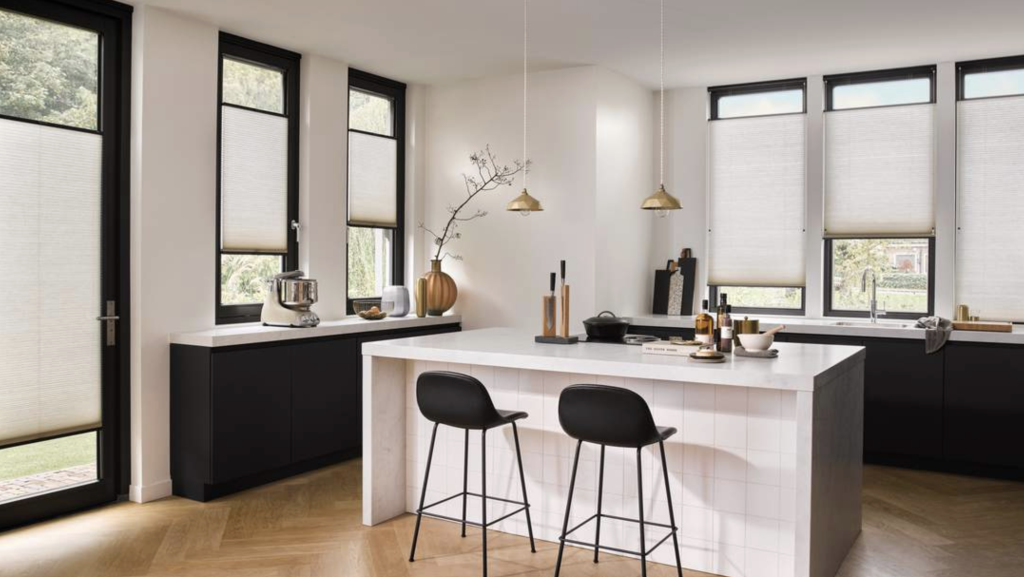 Black and white kitchen with an central island and thermal blinds used to insulate windows from heat