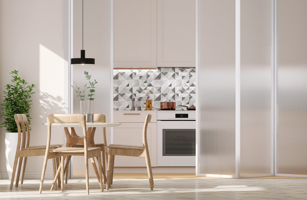 Modern kitchen and dining area in an apartment with fluted glass sliding doors