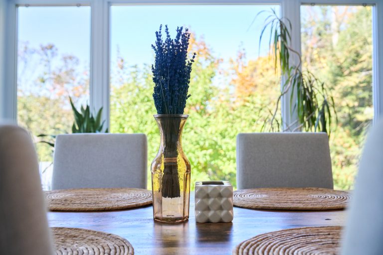 Vue des arbres à travers les fenêtres d’une salle à manger rénovée