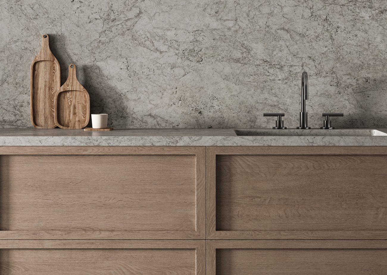 Worktop with stone sink and backsplash in a kitchen with dark wood drawers