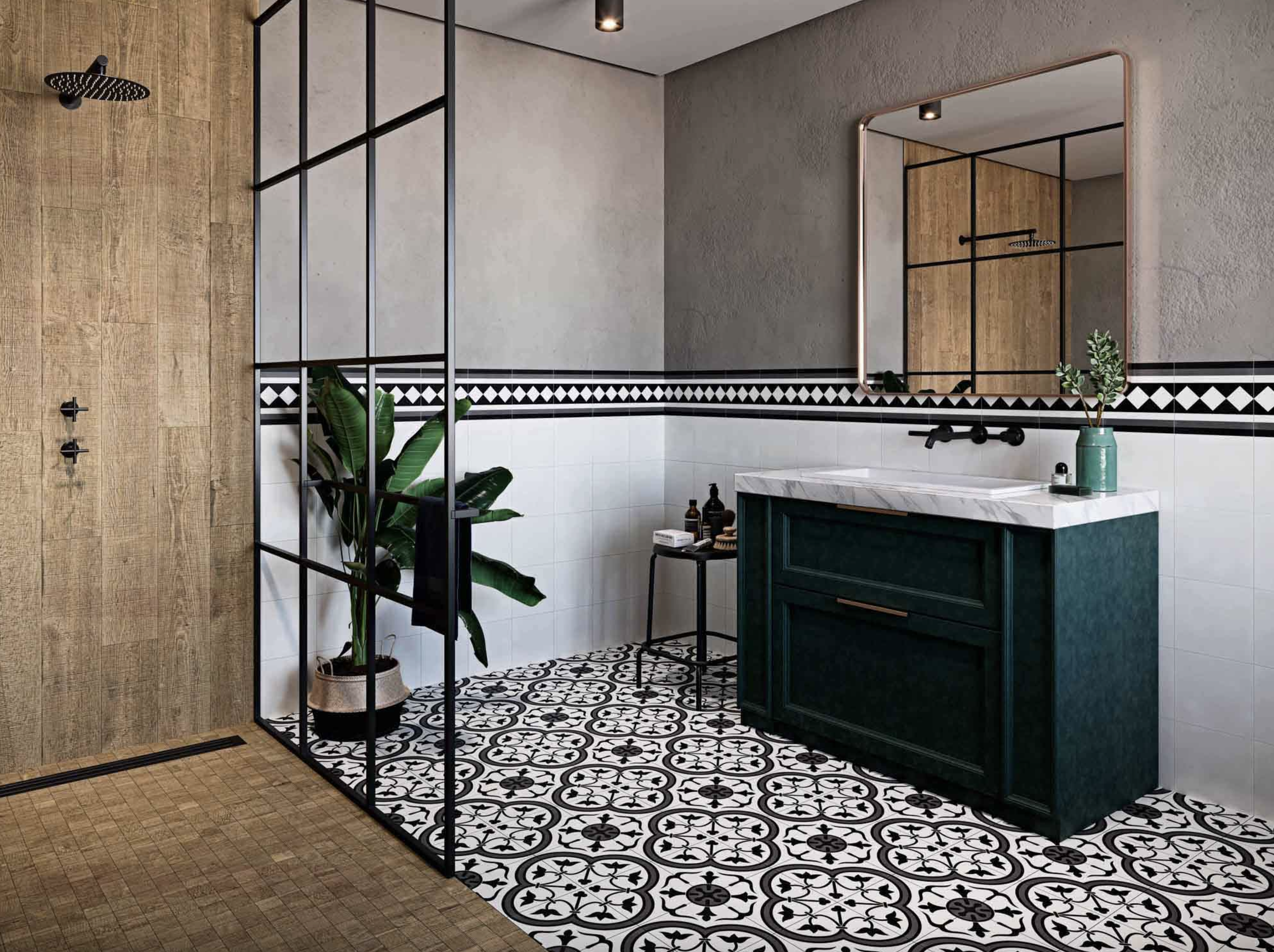 Bathroom with black and white ceramic floor tile featuring rosette patterns, dark green vanity with marble countertop, white tile wainscoting highlighted by a row of checkerboard tile, wood-effect tile shower, large mirror and potted plant