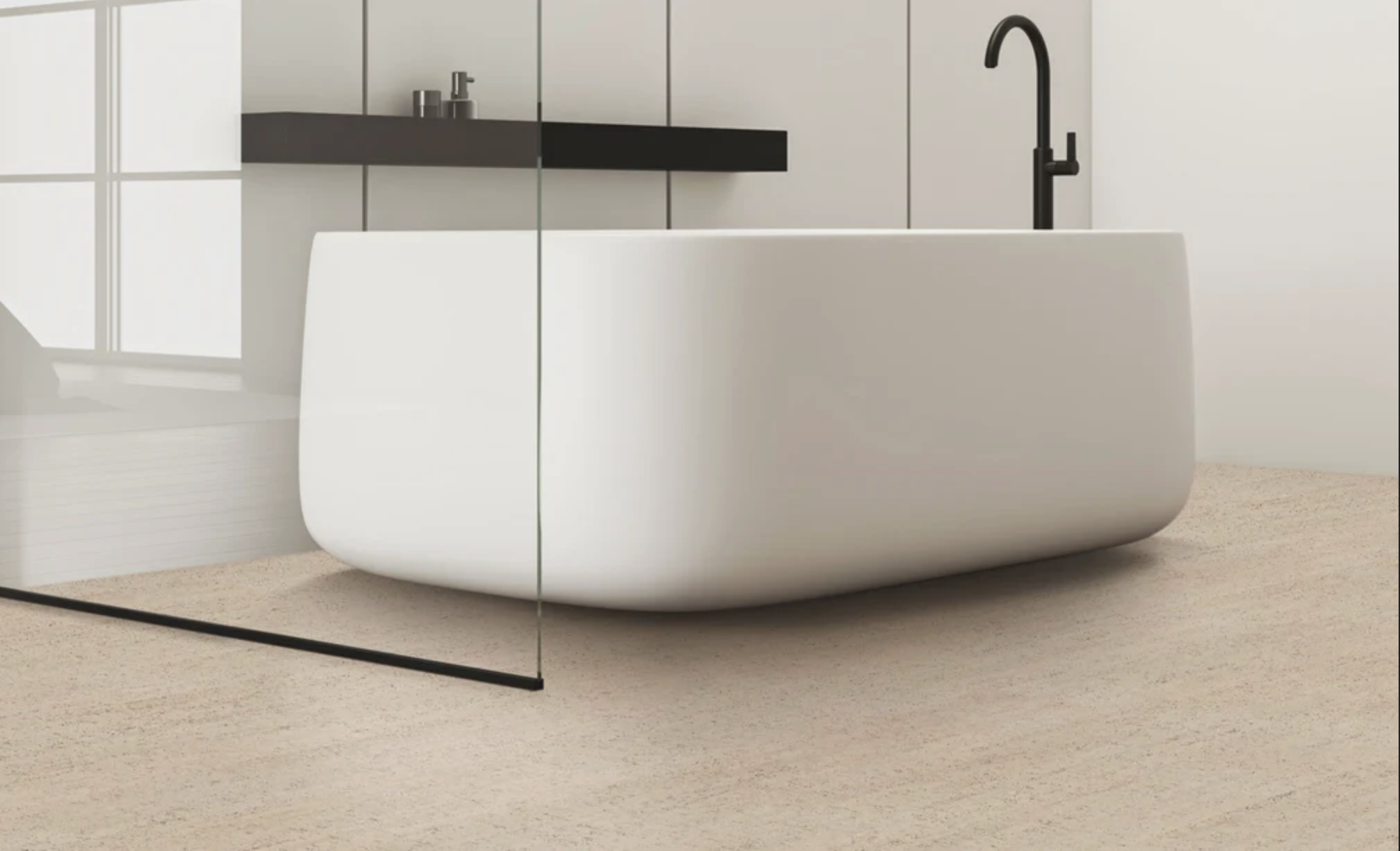 White freestanding bathtub with black faucet, black shelf with beauty products, glass partition and beige sand cork floor